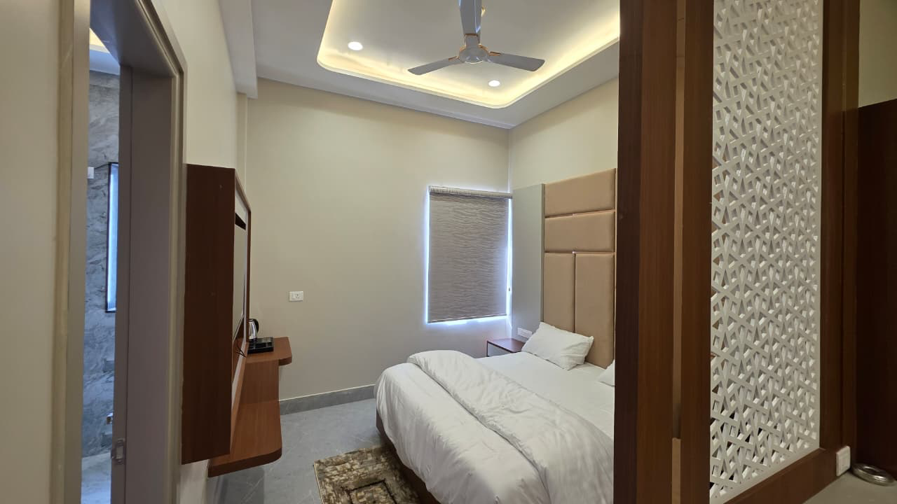 Room with carved jaali partition and bed